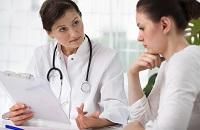 2 doctors having a discussion over a clipboard